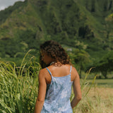 woman with brown hair wearing blue paniolo print overall style romper with bandeau