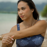 woman wearing a sports bra with blue hibiscus pattern