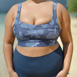 woman wearing a sports bra with blue hibiscus pattern