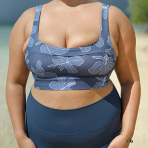 woman wearing a sports bra with blue hibiscus pattern