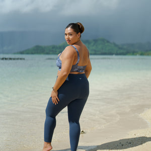 woman wearing a sports bra with blue hibiscus pattern