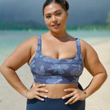 woman wearing a sports bra with blue hibiscus pattern