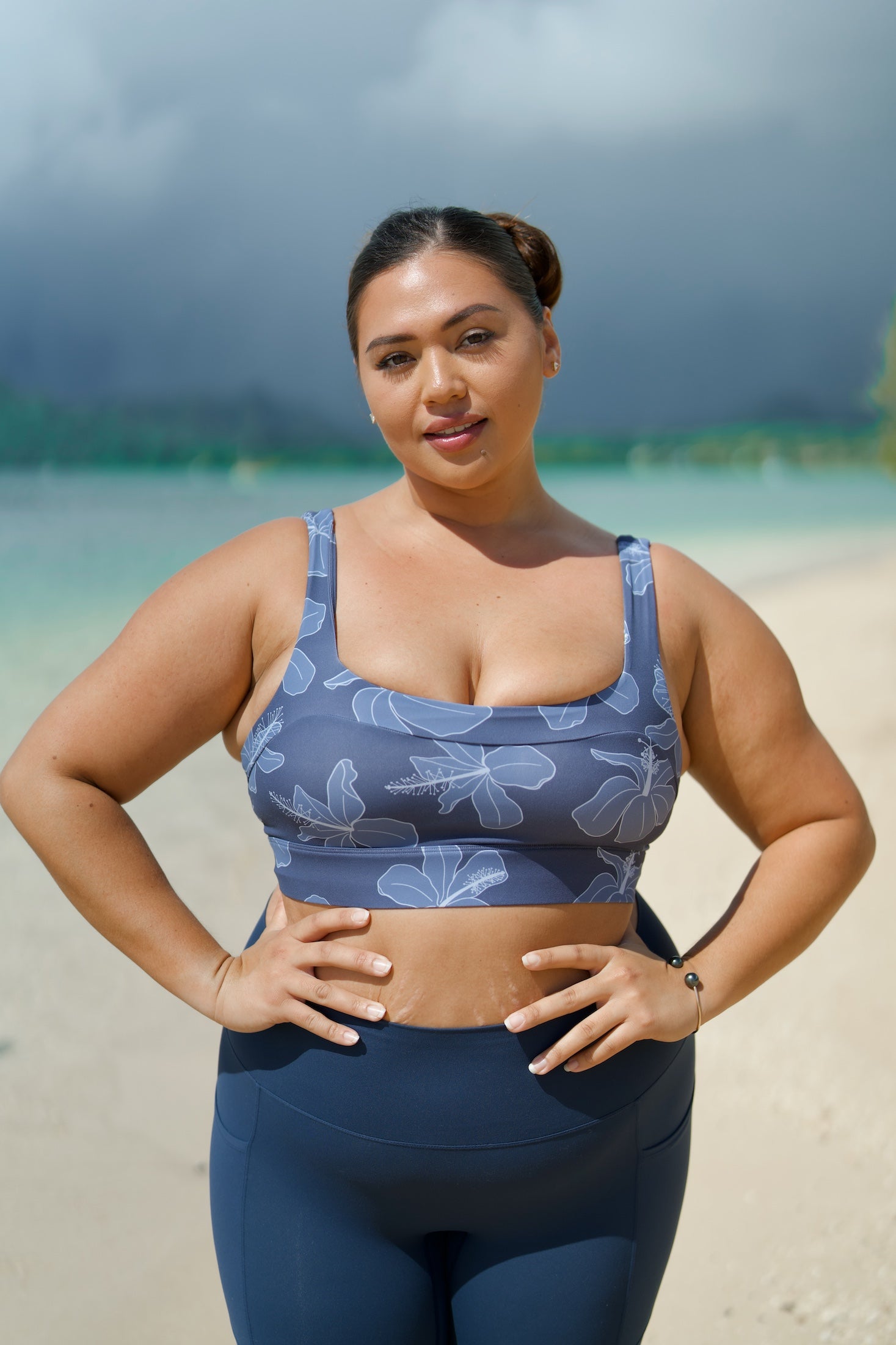 woman wearing a sports bra with blue hibiscus pattern