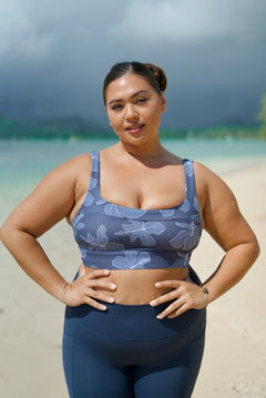 woman wearing a sports bra with blue hibiscus pattern