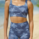woman wearing a sports bra with blue hibiscus pattern