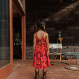 little girl wearing tie back dress with retro pink pua pattern