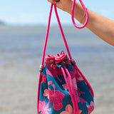 deep blue/teal neoprene drawstring crossbody purse with colorful floral pattern 