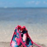 deep blue/teal neoprene drawstring crossbody purse with colorful floral pattern 