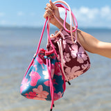 deep blue/teal neoprene drawstring crossbody purse with colorful floral pattern 