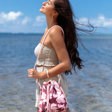brown neoprene drawstring crossbody purse with pink hibiscus pattern