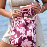 brown neoprene drawstring crossbody purse with pink hibiscus pattern