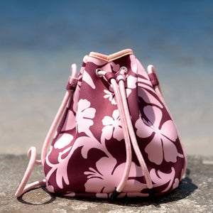 brown neoprene drawstring crossbody purse with pink hibiscus pattern