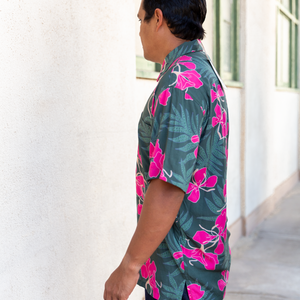 man with brown hair wearing men's aloha button up top with fern and ginger print