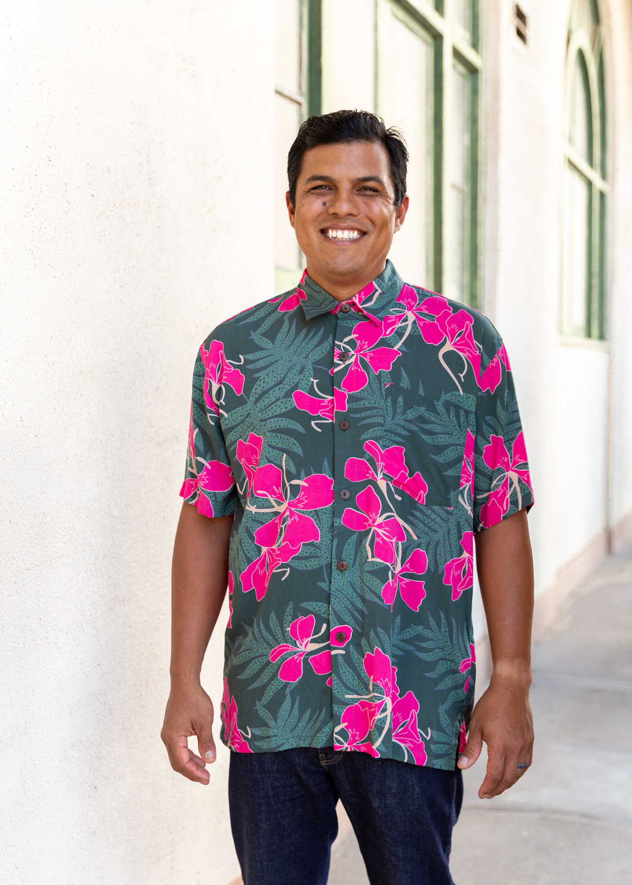 man with brown hair wearing men's aloha button up top with fern and ginger print