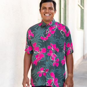 man with brown hair wearing men's aloha button up top with fern and ginger print