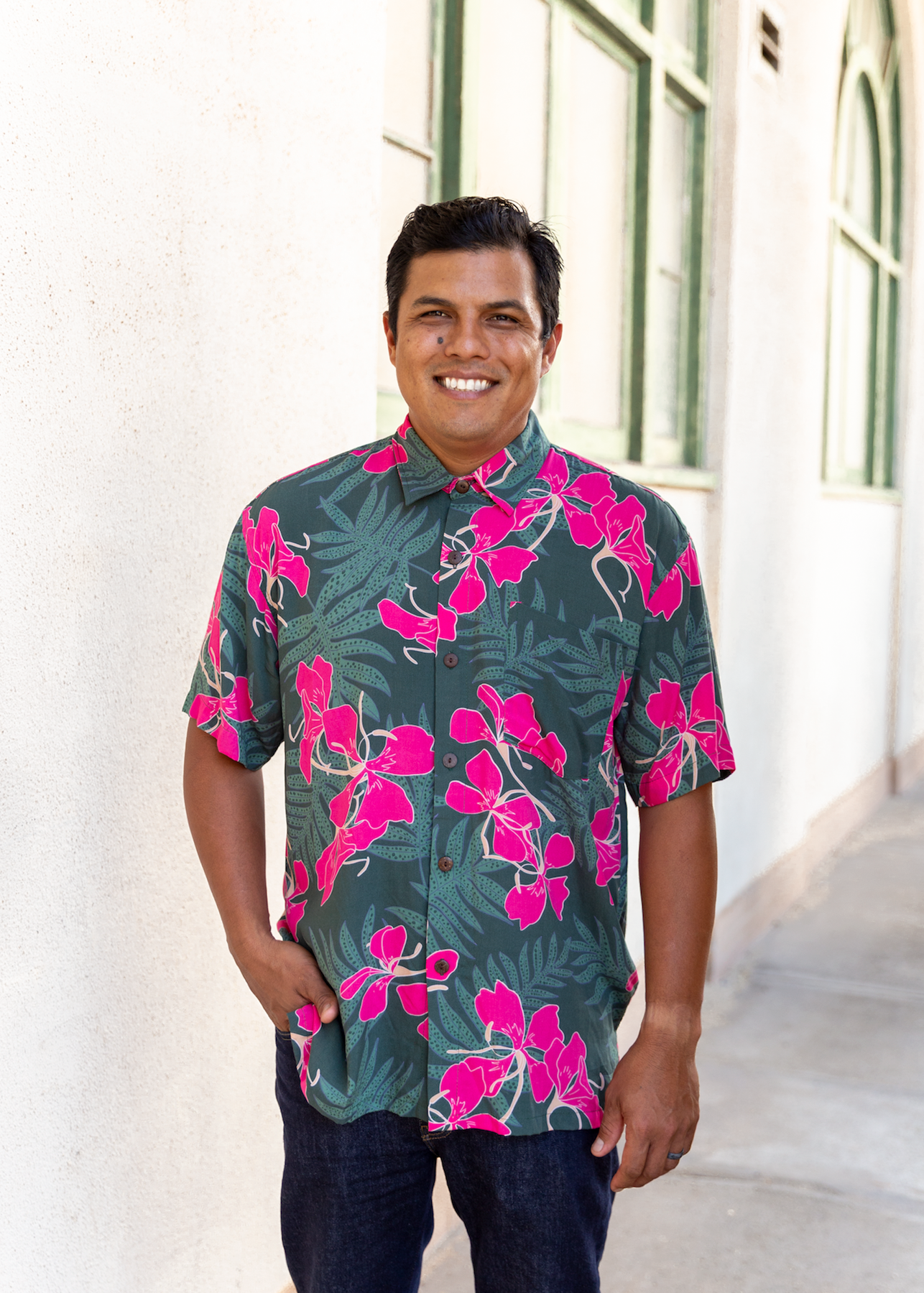 man with brown hair wearing men's aloha button up top with fern and ginger print