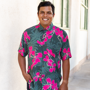 man with brown hair wearing men's aloha button up top with fern and ginger print