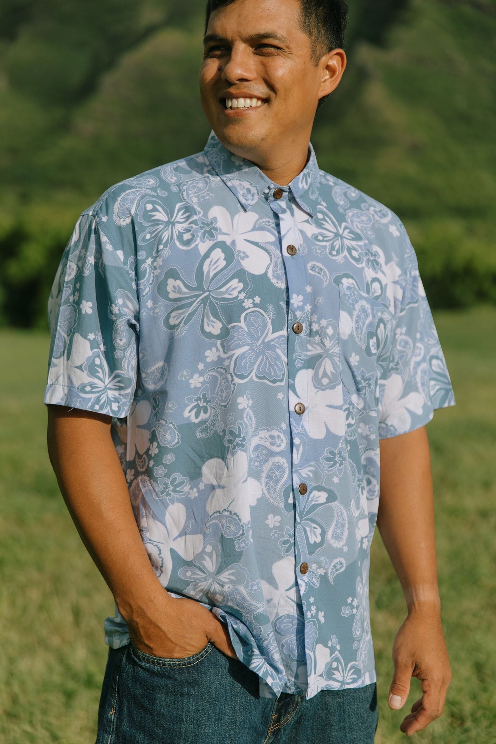 man wearing blue paisley printed aloha button up shirt
