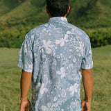 man wearing blue paisley printed aloha button up shirt