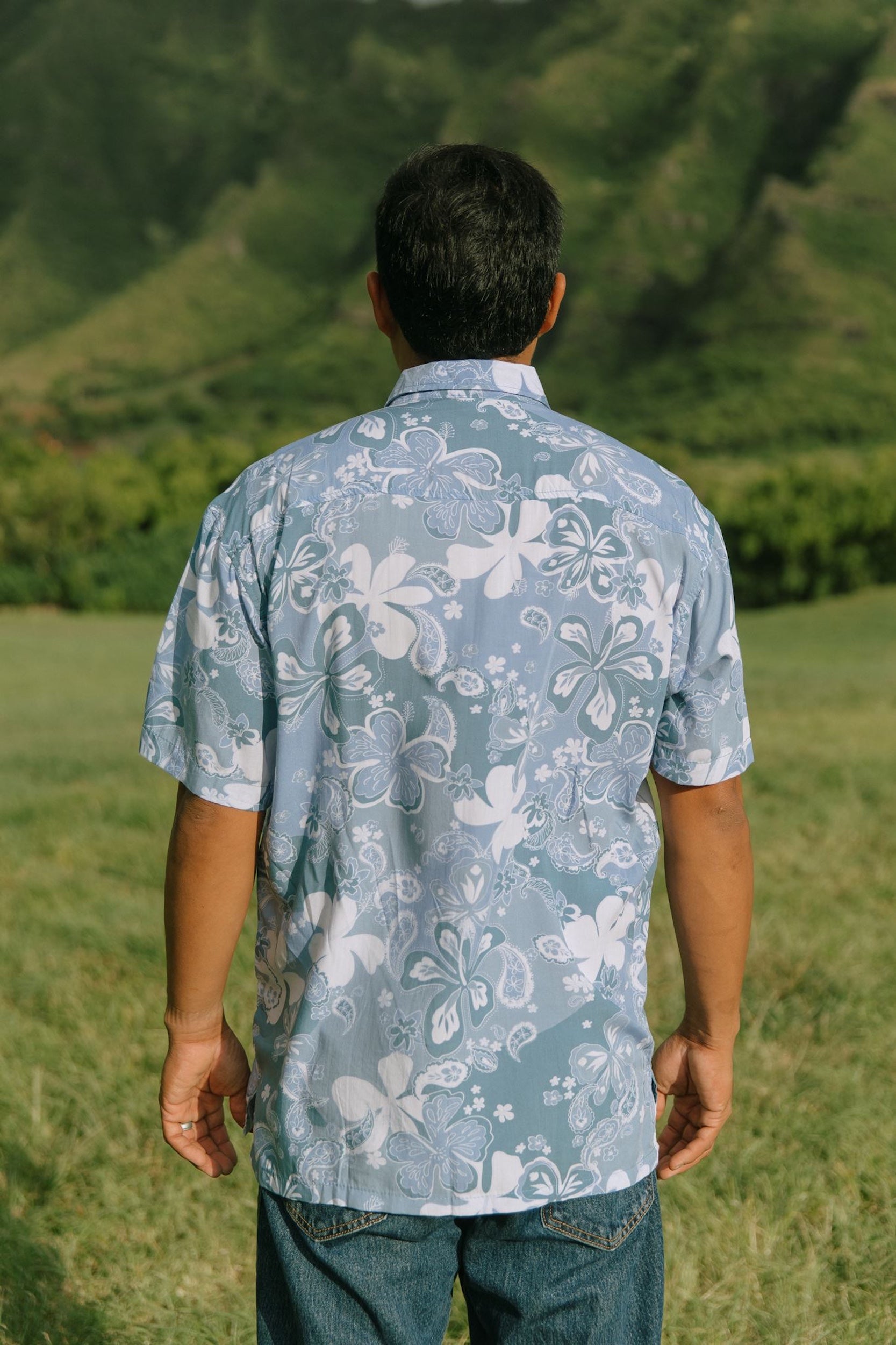 man wearing blue paisley printed aloha button up shirt