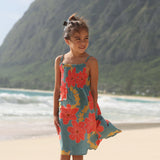 little girl wearing a green knee length dress with orange and yellow lei pua print 