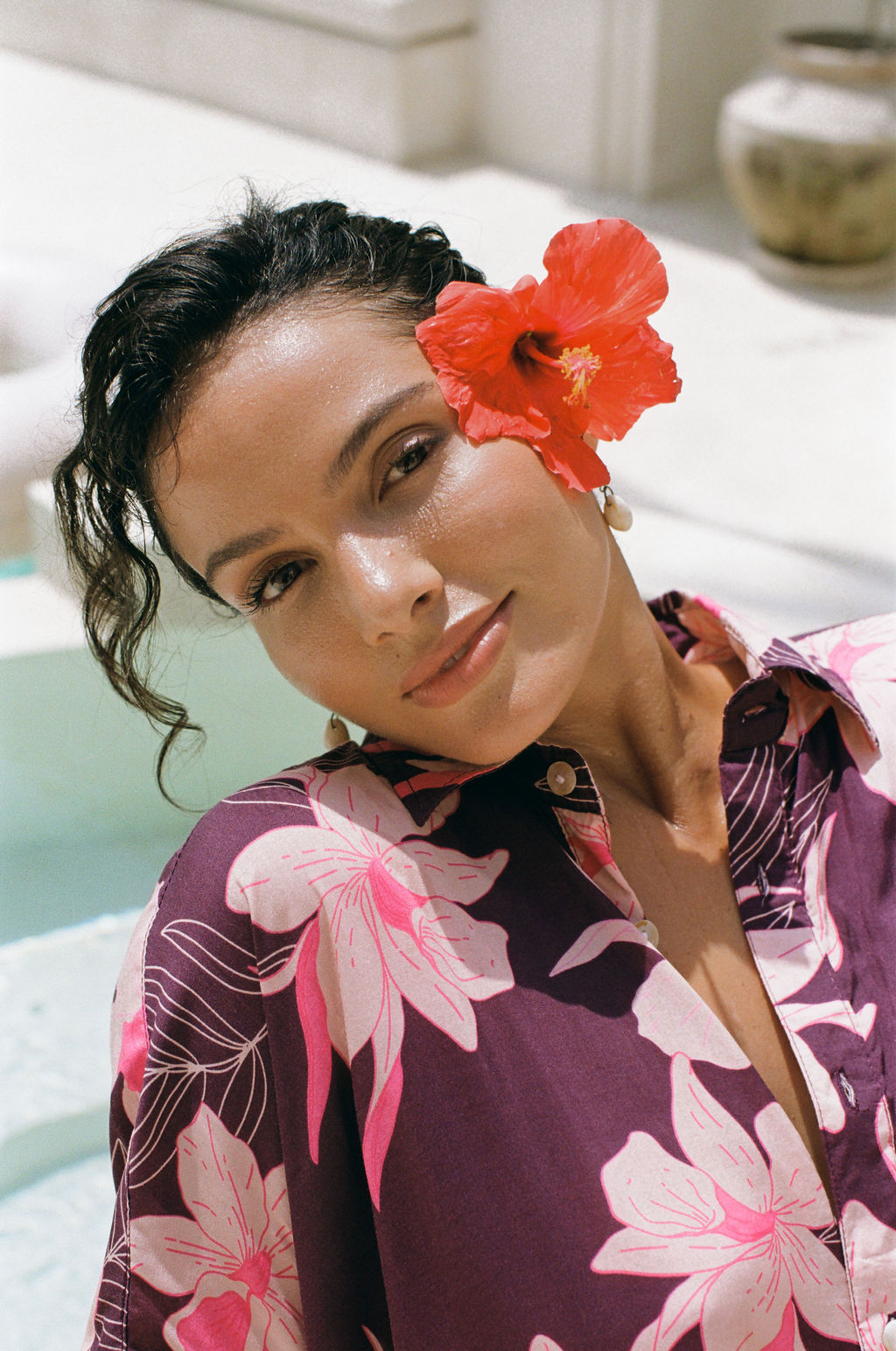 woman wearing an oversized button up shirt dress in dark purple color with orchid print