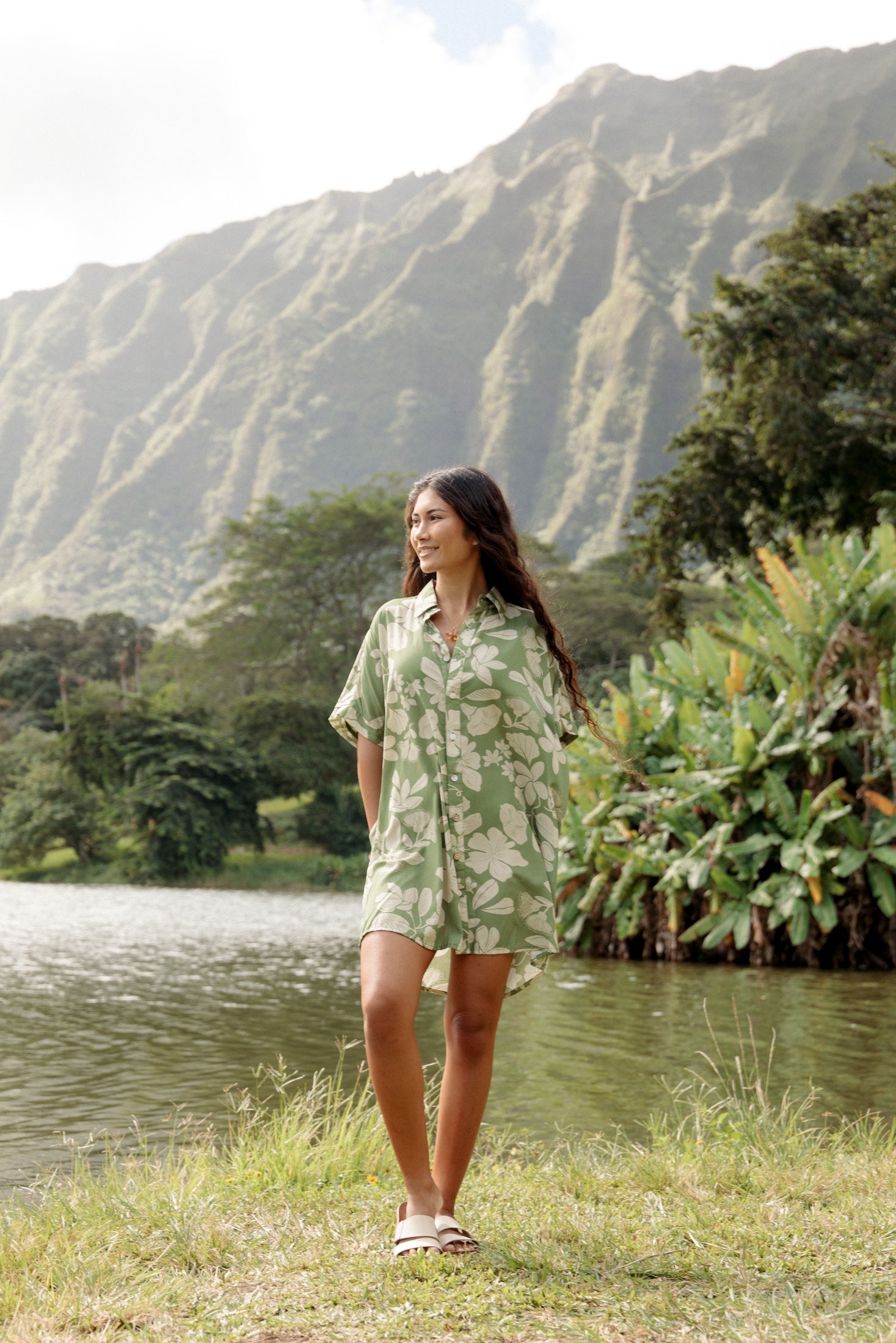 woman with brown hair wearing green collared button up dress with native Hawaiian plants