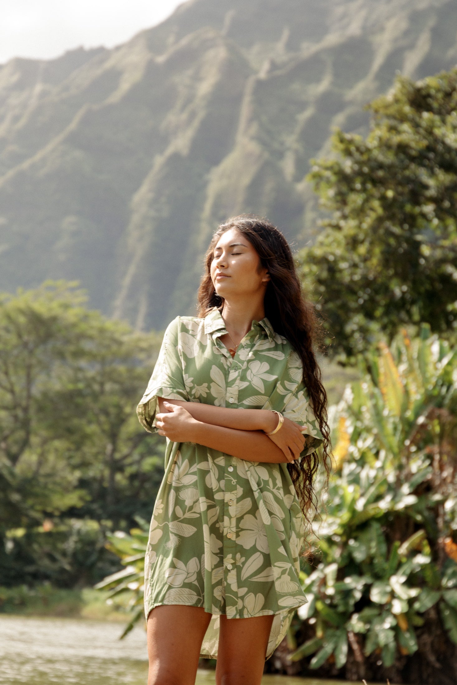 woman with brown hair wearing green collared button up dress with native Hawaiian plants