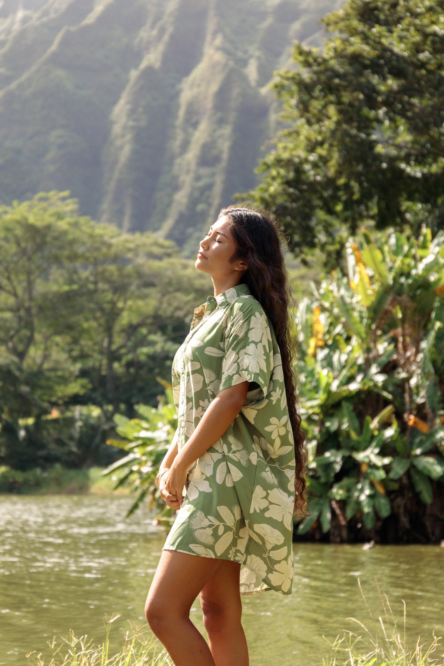woman with brown hair wearing green collared button up dress with native Hawaiian plants