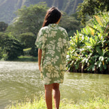 woman with brown hair wearing green collared button up dress with native Hawaiian plants