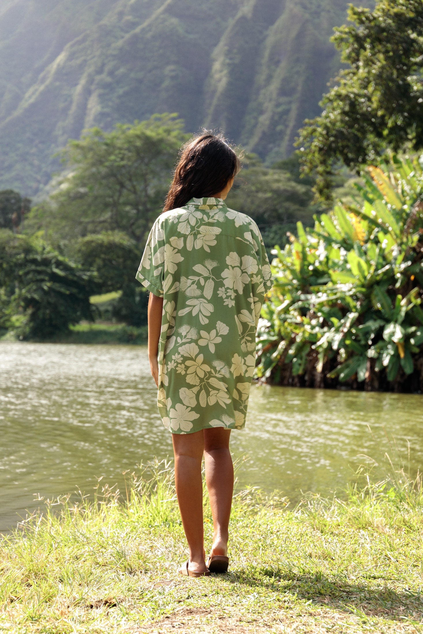woman with brown hair wearing green collared button up dress with native Hawaiian plants