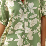 woman with brown hair wearing green collared button up dress with native Hawaiian plants