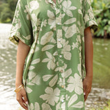 woman with brown hair wearing green collared button up dress with native Hawaiian plants