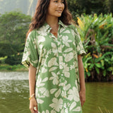 woman with brown hair wearing green collared button up dress with native Hawaiian plants