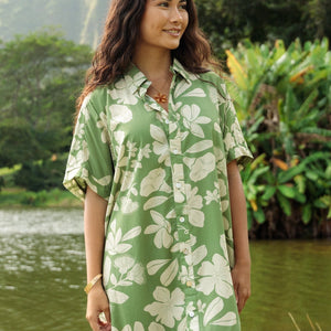woman with brown hair wearing green collared button up dress with native Hawaiian plants