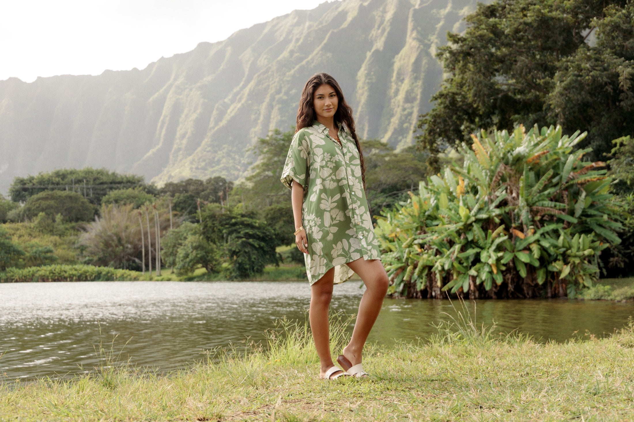woman with brown hair wearing green collared button up dress with native Hawaiian plants