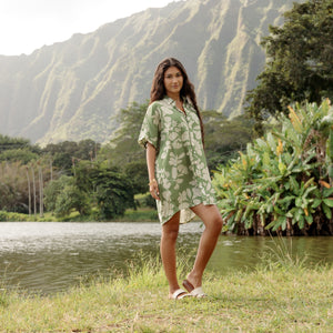 woman with brown hair wearing green collared button up dress with native Hawaiian plants