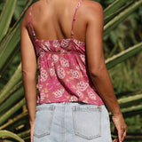 woman with brown hair wearing a pink spaghetti strap top with bow detail with shell and pua print