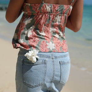 woman with blonde hair wearing jade colored tank top with tiare ginger print