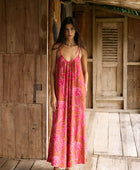 A woman with dark hair wears a YIREH v-neck, wide legged jumpsuit. It is the Laney Jumpsuit in the Garden 'Awapuhi print. 