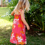 little girl wearing a pink tie strap maxi dress with retro flower pattern
