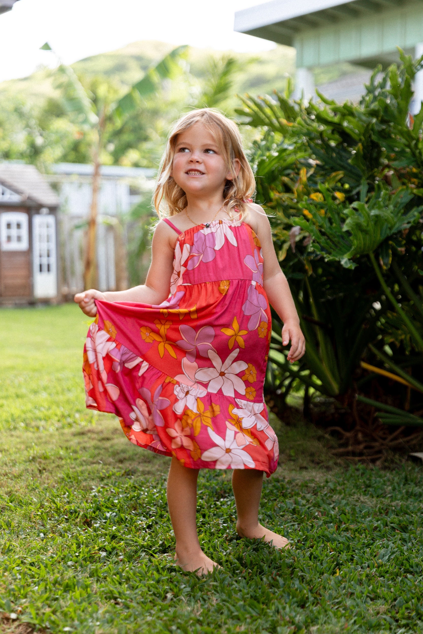 little girl wearing a pink tie strap maxi dress with retro flower pattern