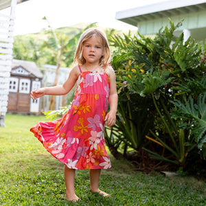 little girl wearing a pink tie strap maxi dress with retro flower pattern