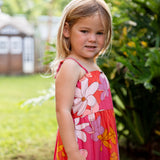 little girl wearing a pink tie strap maxi dress with retro flower pattern