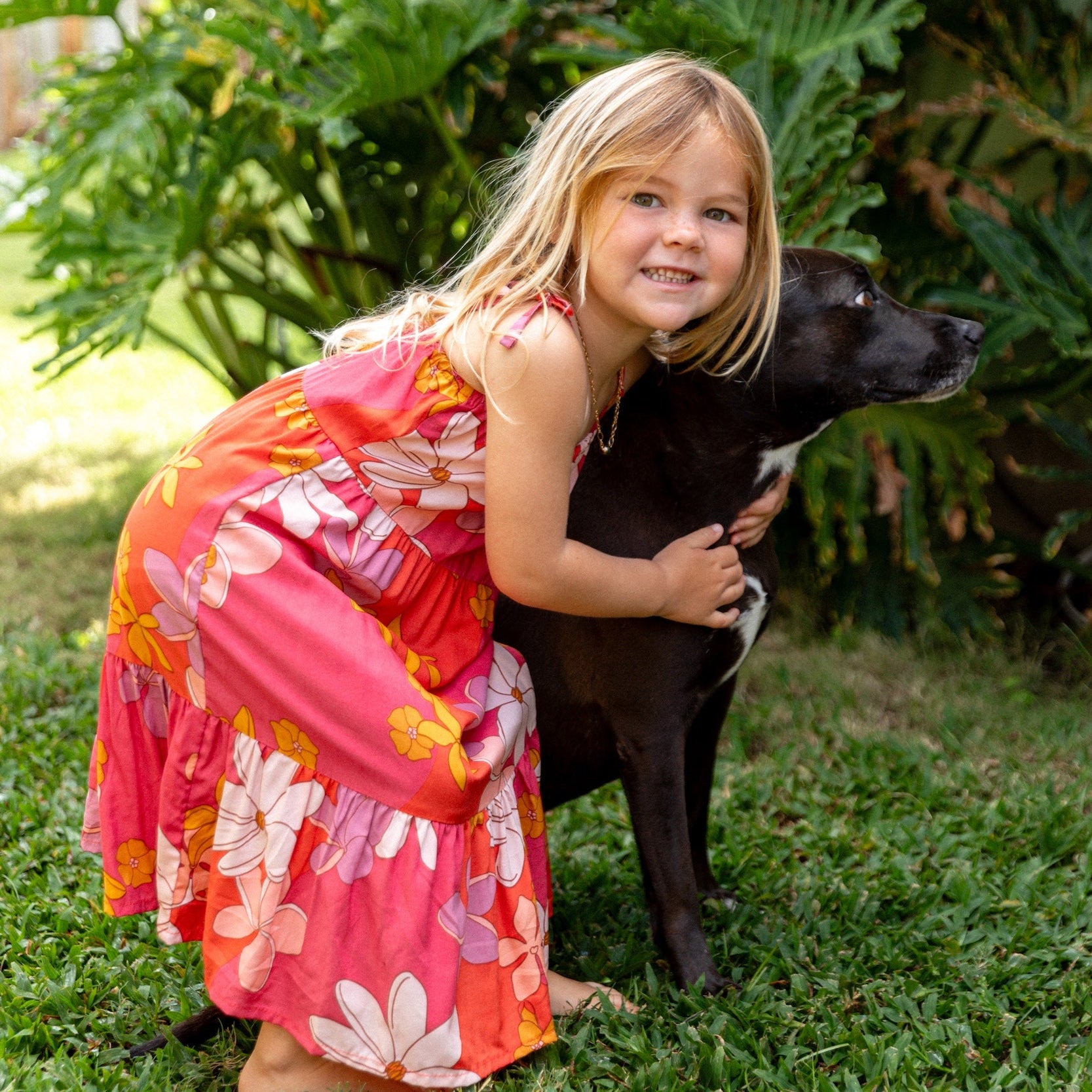 little girl wearing a pink tie strap maxi dress with retro flower pattern
