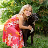 little girl wearing a pink tie strap maxi dress with retro flower pattern
