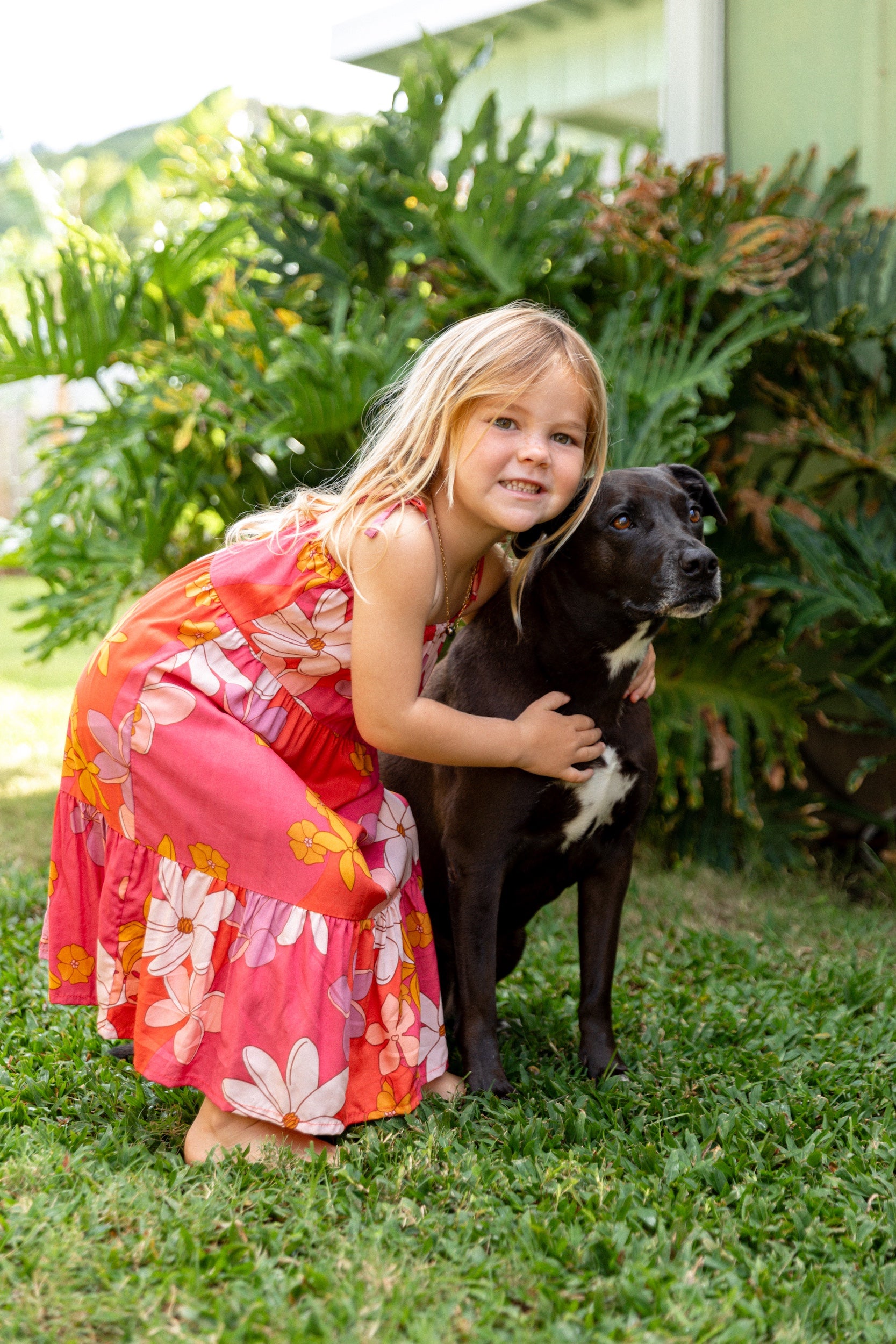 little girl wearing a pink tie strap maxi dress with retro flower pattern