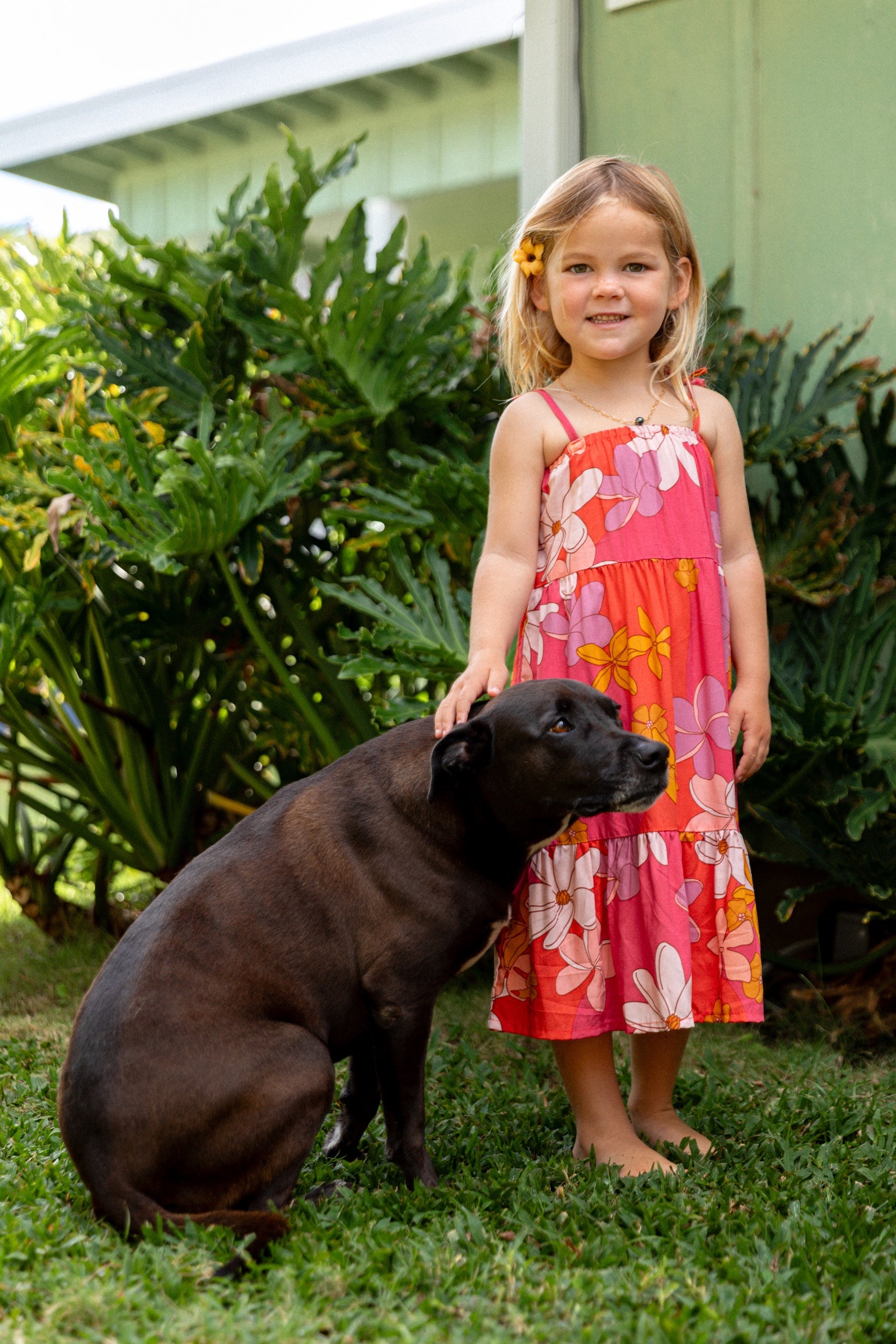 little girl wearing a pink tie strap maxi dress with retro flower pattern