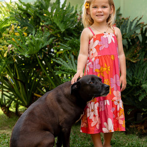 little girl wearing a pink tie strap maxi dress with retro flower pattern