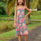 little girl wearing long teal dress with tie sleeve and floral pattern
